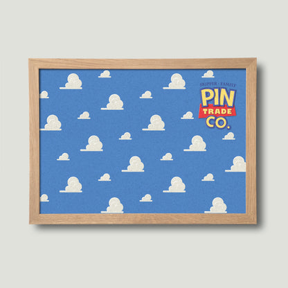 landscape version of wooden framed pin board with blue sky and clouds design in background. Toyistory themed graphic.